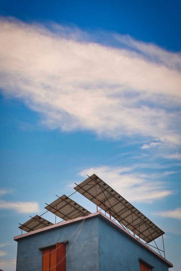 Home Solar panels mounted on a rooftop against a clear blue sky.